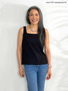 Miik model Lisa (5'6", xsmall) wearing Miik's Eline reversible shelf bra tank in black with jeans 