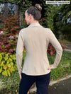 Miik model Johanna, size XS, showing the back of the Emily soft blazer in oatmeal melange.
