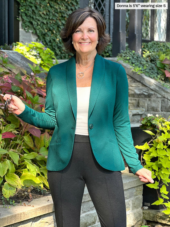 Miik founder Donna (size small, 5 foot 6) wearing the Emily soft blazer in jade melange green as a suit with tailored pants.