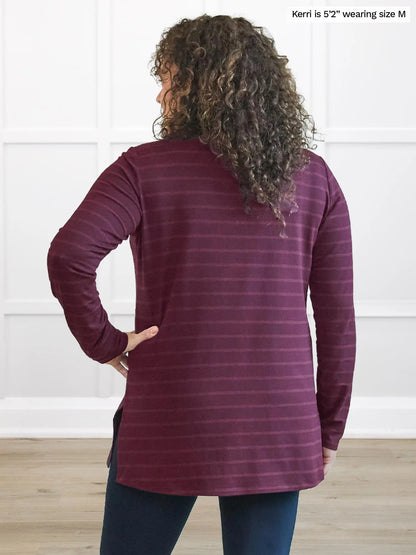 Miik model Kerri (5’2”, medium) standing with her back towards the camera showing the back of Miik&