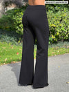 A close up image of the back of Miik's Jeremy high waisted wide leg ponte pant in black