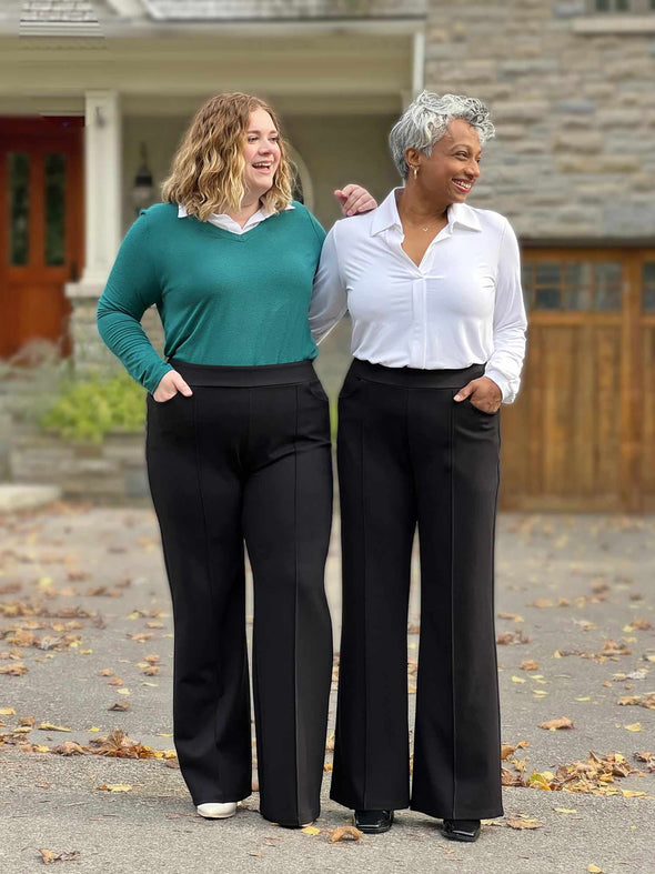 Miik models Bri and Keethai smiling and both looking away wearing Miik's Jeremy high waisted wide leg ponte pant in black