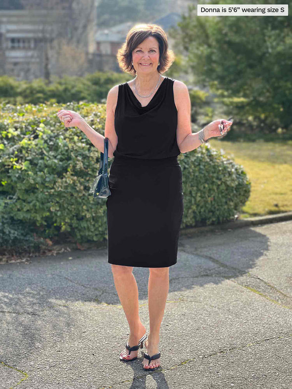 Miik founder Donna (5'6", small) smiling wearing Miik's Jilly pull-on pencil skirt in black with a top in the same colour 