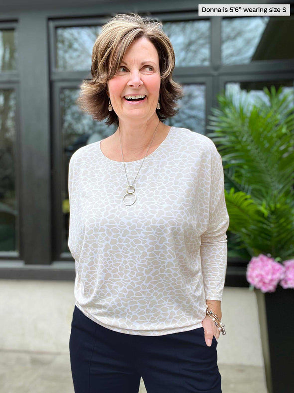 Miik founder Donna (five feet six, small) smiling wearing Miik's Kallyn slouchy dolman long sleeve top in the cobblestone print