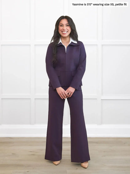 Woman wearing a purple outfit with a white shirt against a white background 
