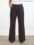 Dark brown petite wide-leg pants worn by a person on a white background 