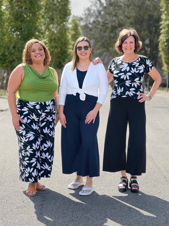 Miik models Carley and Christal along with founder Donna standing next to each other smiling showing different ways of styling the Miik's Keethai wide leg culotte and its different colours and print 