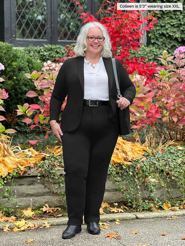 Miik model Colleen (5'3", xxlarge) smiling wearing Miik's Keltie ponte mid-rise slim pant in black along with a collared white shirt and a black blazer