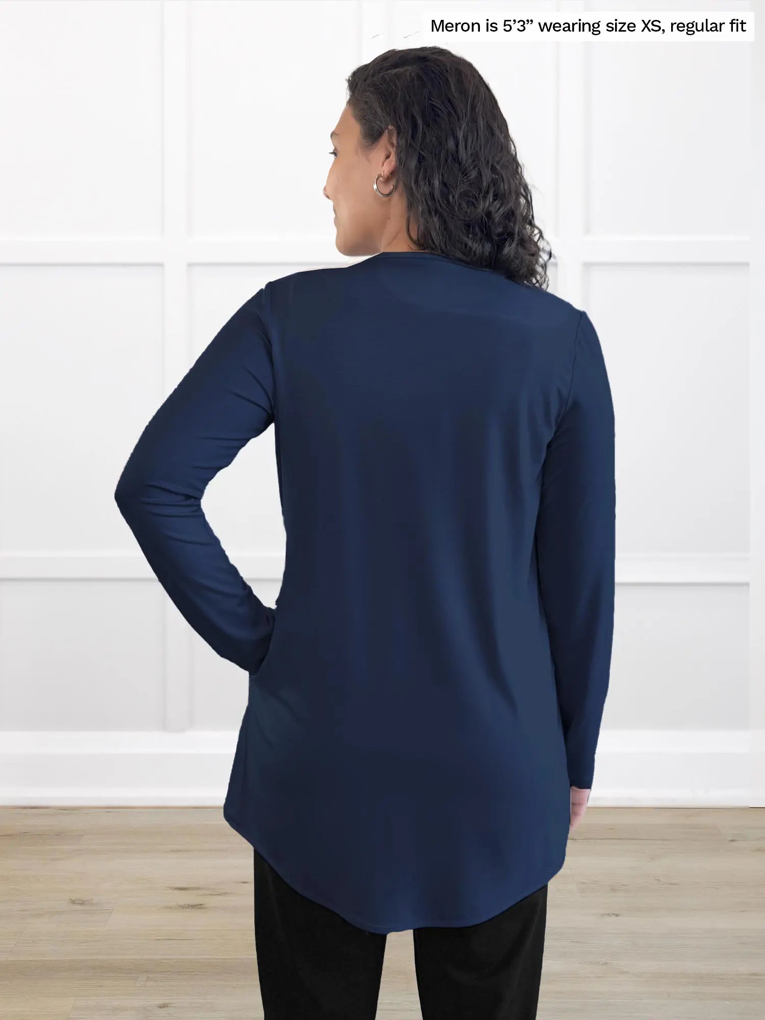 Miik model Meron (5’3”, xsmall) standing with her back towards the camera showing the back of Miik&