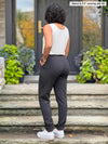 Miik model Meron (5’3”, xsmall) standing with her back towards the camera showing the back of Miik's Linaya luxe fleece jogger 