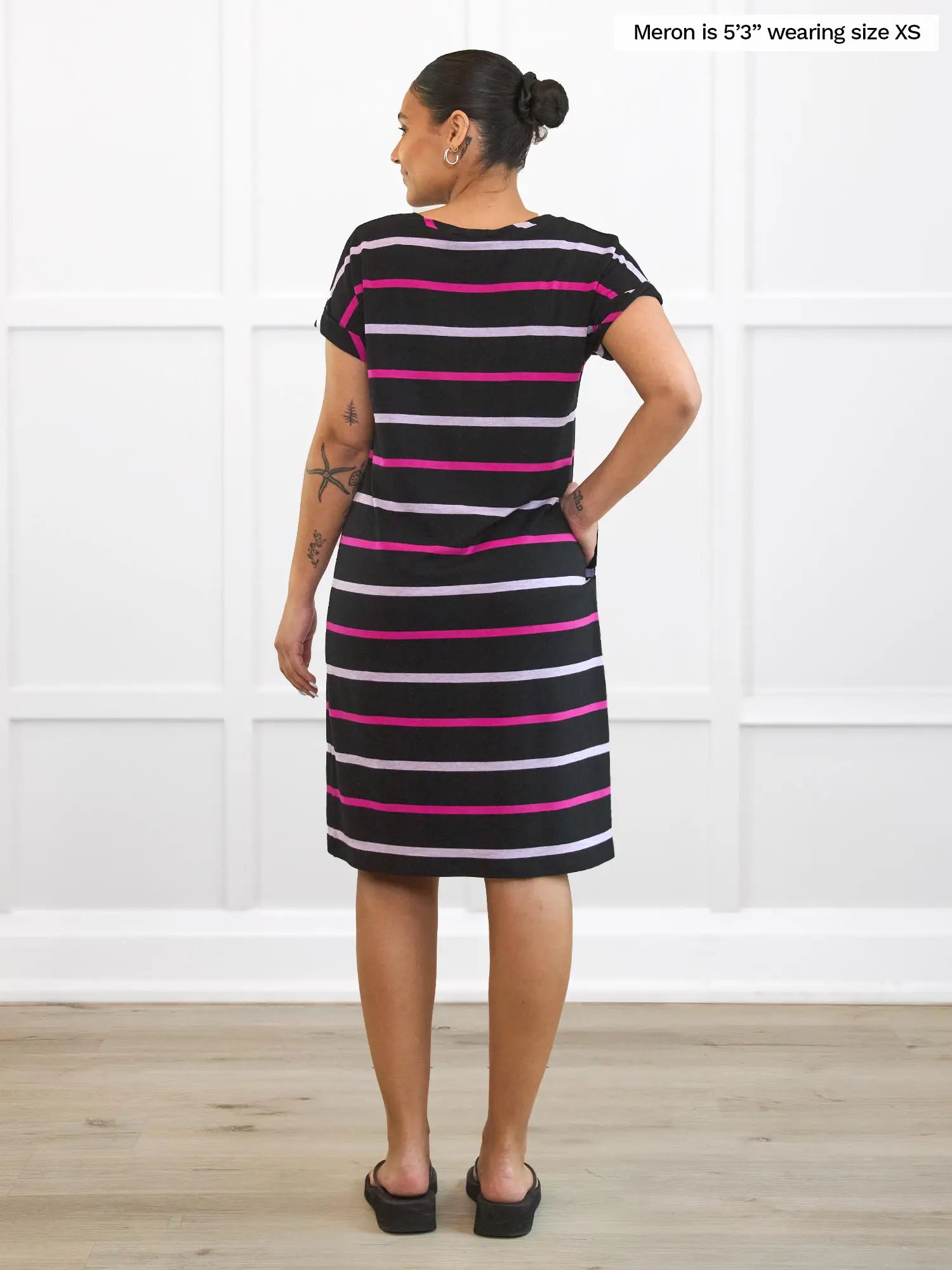 Miik model Meron (5’3”, xsmall) standing with her back towards the camera showing the back of Miik&