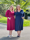 Miik models Bri and Kelly standing next to each other smiling both wearing Miik's Lolly midi flounce dress with pockets