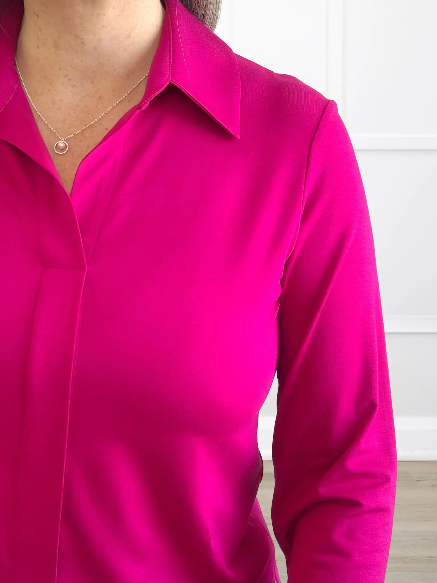 A close up detail shot of the collared neckline of the Miik&