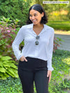 Miik model Meron (5'3", xsmall) wearing the Lucia collared dress shirt in white tucked into black pants.