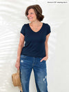 Miik founder Donna (5'6", small) smiling wearing Miik's Marianna reversible classic tee in navy with jeans 