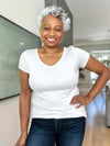 Miik model Keethai (5'5", medium) smiling wearing Miik's Marianna reversible classic tee in white with jeans