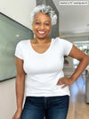 Miik model Keethai (5'5", medium) smiling wearing Miik's Marianna reversible classic tee in white with jeans 