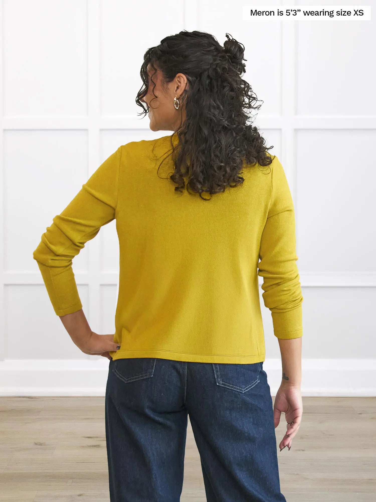 Miik model Meron (5’3”, xsmall) standing with her back towards the camera showing the back of Miik&