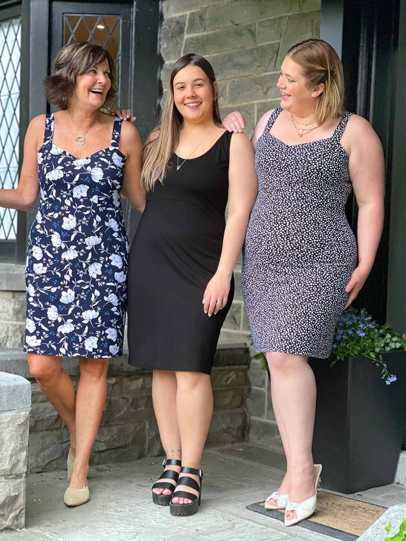 Miik models Christal and Brin standing next to Miik founder Donna all wearing Miik's Maryse reversible sweetheart dress in the three colours available: blossom, black and starry night
