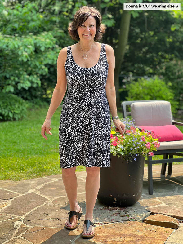 Miik founder Donna (five feet six, small) smiling wearing Miik's Maryse reversible sweetheart dress in starry night print 