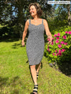 Miik founder (five feet six, small) walking on her backyard looking away wearing Miik's Maryse reversible sweetheart dress in starry night