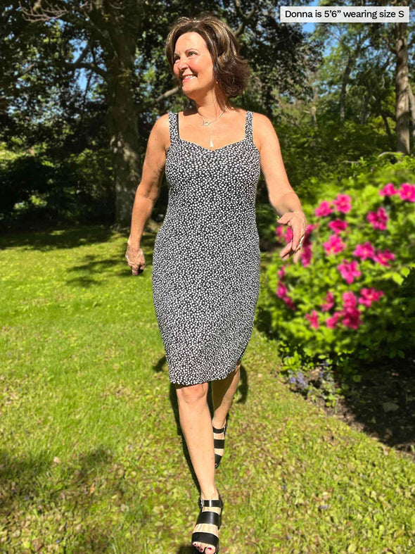Miik founder (five feet six, small) walking on her backyard looking away wearing Miik's Maryse reversible sweetheart dress in starry night