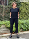 Miik fonder Donna (5'6", small) wearing an all black outfit: Miik's Melody side tie top and a capri pant 