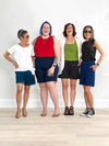 Miik models Bonnie, Kaitlin, Lisa and founder Donna smiling while standing next to each other all wearing the different Miik short: Leland and Irelynn 