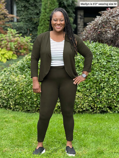Miik model Marilyn (52&quot;, medium) smiling wearing a olive legging, petite fit, along with a cropped cardigan in the same matching colour and Miik&