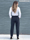 Miik model Johanna (five feet six, size xsmall) standing with her back towards the camera showing the back of Miik's Nida pleat front tapered pant