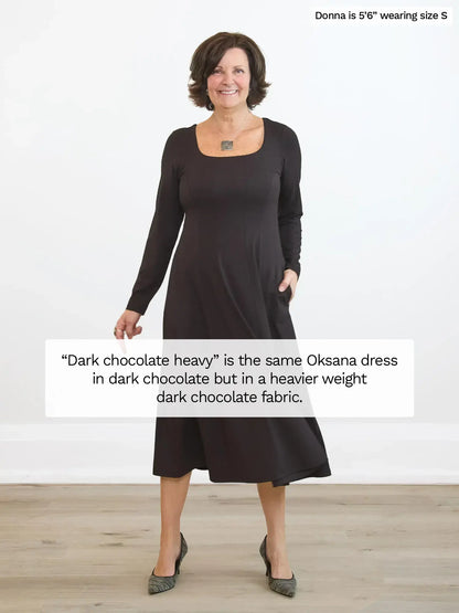 Woman wearing a dark chocolate dress with text about fabric weight. 
