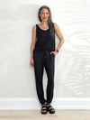 Miik model Lisa (5'6", xsmall) smiling wearing Miik's Perle open-back sleeveless jumpsuit in black 