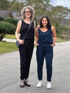 Miik models Liane and Meron standing next to each other both wearing Miik's Perle open-back sleeveless jumpsuit to show the style in different body types and heights 