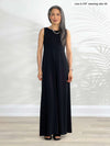 Miik model Lisa (5'6", xsmall) smiling wearing Miik's Prisha reversible maxi dress in black 
