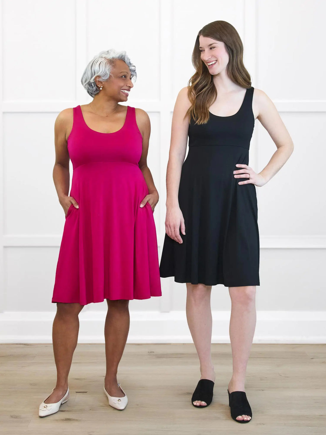 Miik models Keethai and Bethany standing side by side against a white wall both wearing Miik&