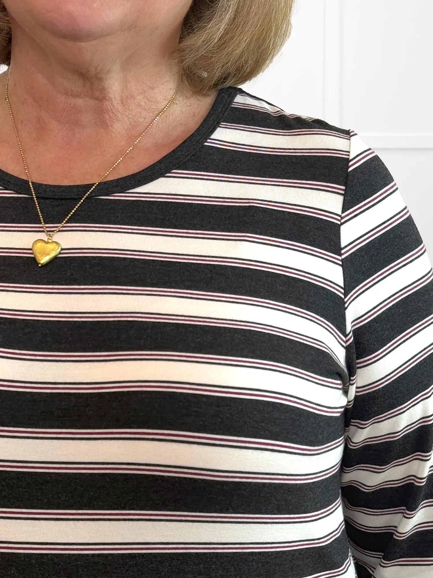 A closeup detail shot of the neckline and stripe of Miik&