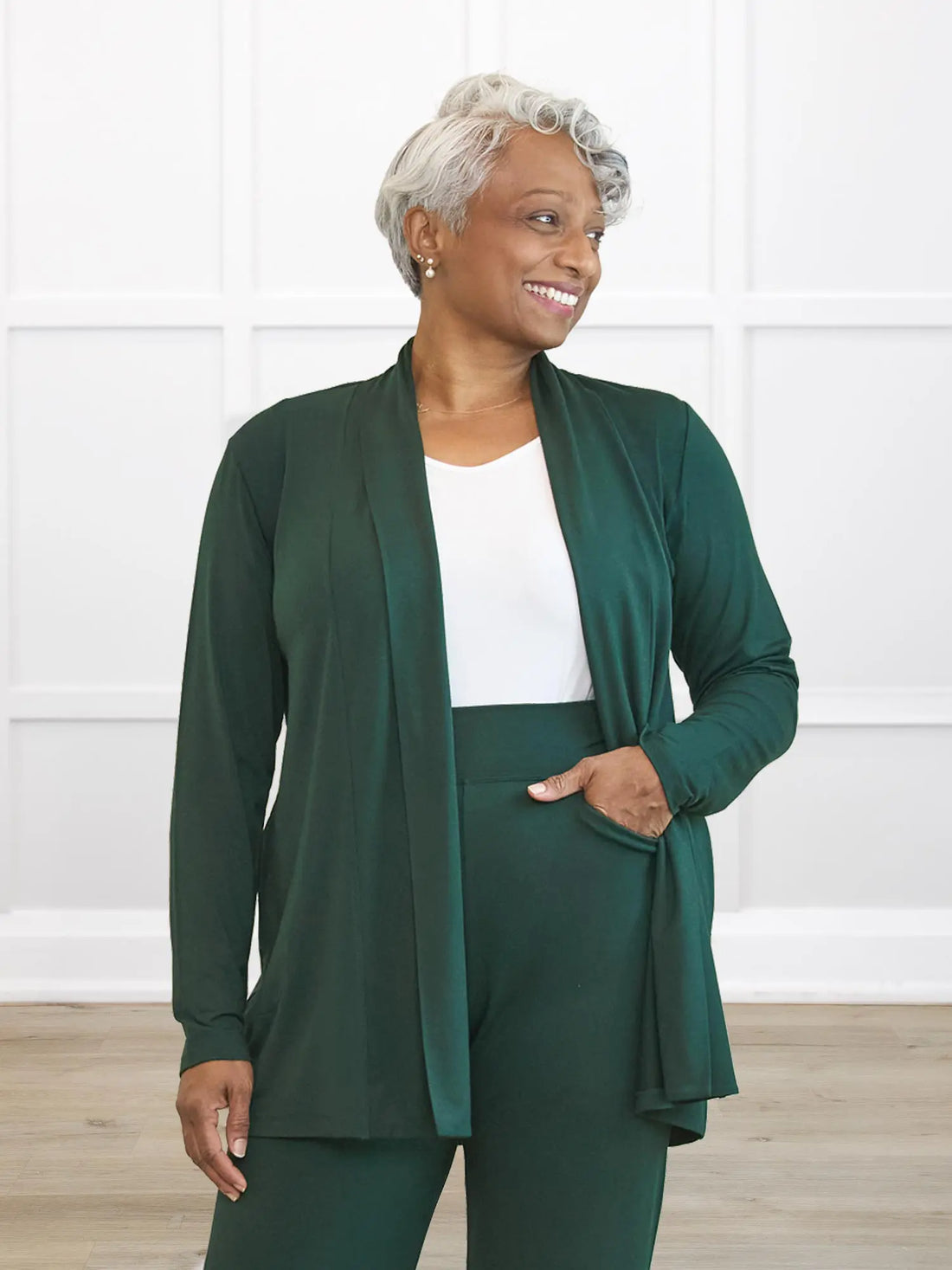 Woman wearing a green outfit with a white background