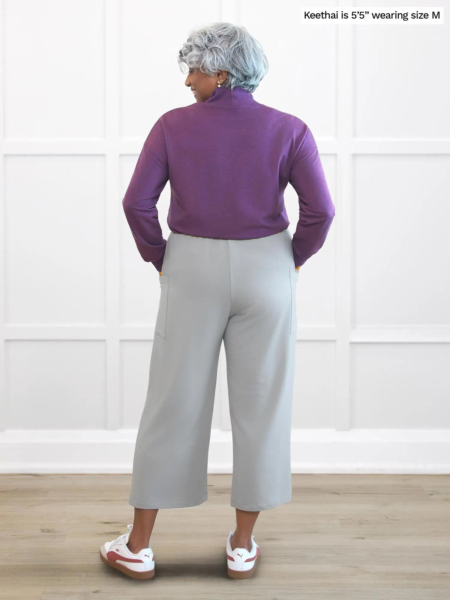 Miik model Keethai (5’5”, medium) standing with her back towards the camera showing the back of Miik&