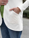 A close up image of the open-front pocket of Miik's Sade cardigan