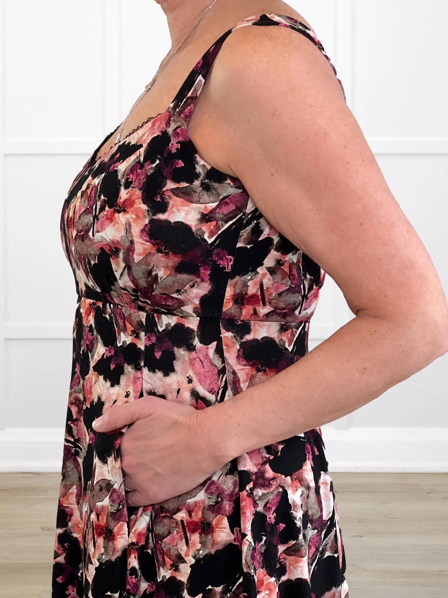 A close-up of the Seville sweetheart midi dress in pink bouquet, showing the side details including hidden pockets. 