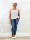 Miik model Keethai (5'5", medium) smiling wearing jeans with Miik's Shandra reversible tank top - coastal stripe