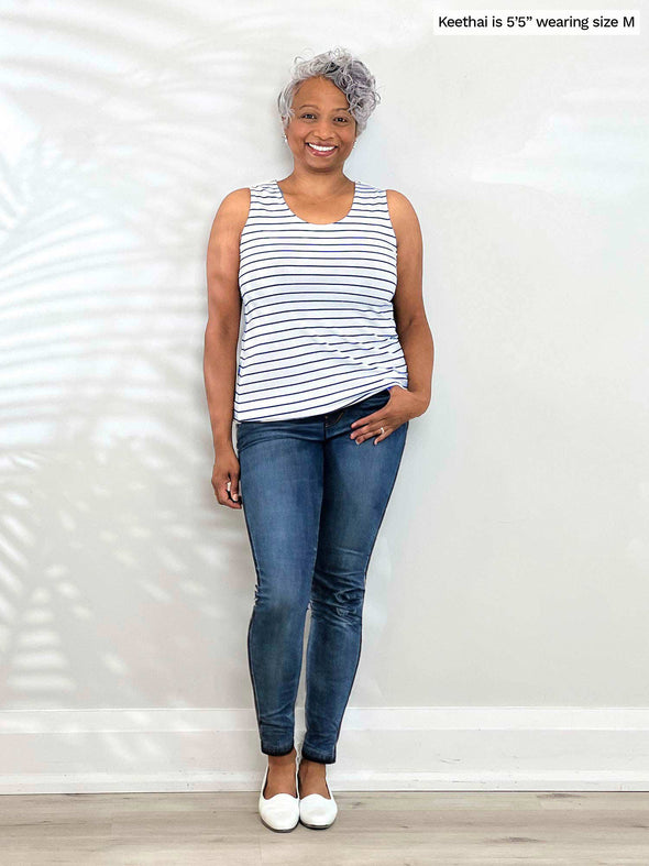Miik model Keethai (5'5", medium) smiling wearing jeans with Miik's Shandra reversible tank top - coastal stripe