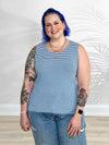 Miik model Kaitlin (5'9", xlarge) smiling wearing Miik's Shandra reversible tank top in cobalt mini stripe with jeans