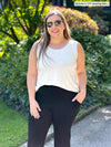 Miik model Christal (size L, five foot three) wearing Shandra reversible tank top in natural, with the scoop neck in front.
