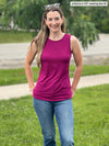 Miik model Johanna (size XS, 5 foot 6) outside while wearing Miik's Shandra reversible tank top in ruby pink.