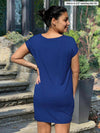 Miik model Meron (5’3”, xsmall) standing with her back towards the camera showing the back of Miik's Sia dolman-sleeve cocoon tunic
