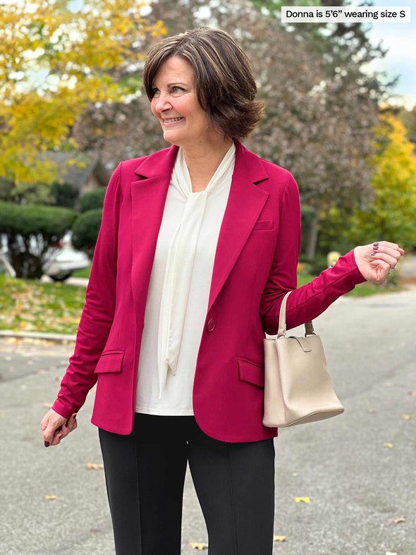 Miik founder Donna (5'6", size small) wearing Miik's Sienna girlfriend blazer in bordeaux red over cream blouse and black dress pants.