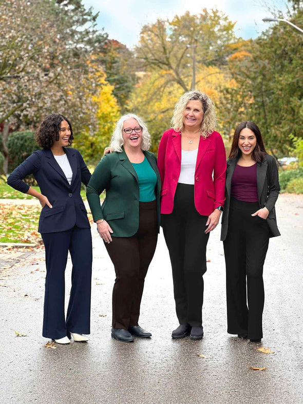 Miik models Meron, Colleen, Carolyn and Yasmine smiling all wearing the different colours of the Sienna girlfriend blazer. Meron is wearing navy, Colleen in pine green, Carolyn in bordeaux and Yasmine in charcoal