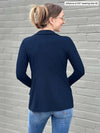 Miik model Johanna (five feet six, size extra small) standing with her back towards the camera showing the back of Miik's Sienna girlfriend blazer in navy