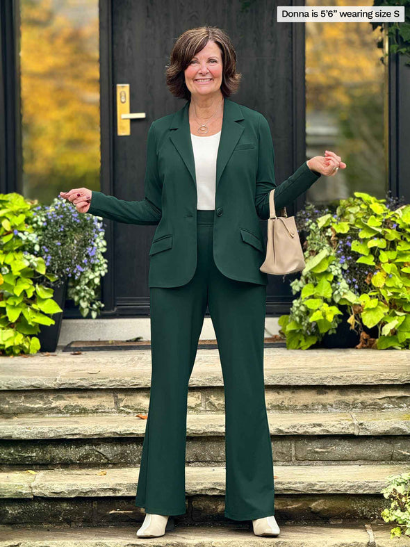 Miik founder Donna wearing the Sienna girlfriend blazer in pine as a tailored suit with the matching pine green Reed pants and a white tank.